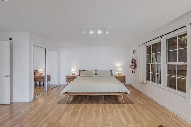 bedroom featuring a closet and light wood-type flooring