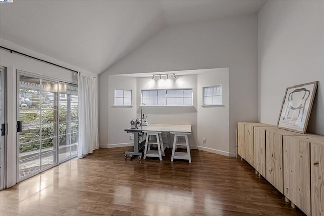 dining area with dark wood-type flooring and lofted ceiling