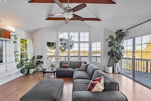 sunroom / solarium featuring ceiling fan and lofted ceiling with beams