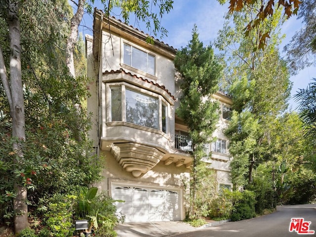 view of front of property with a garage and a balcony