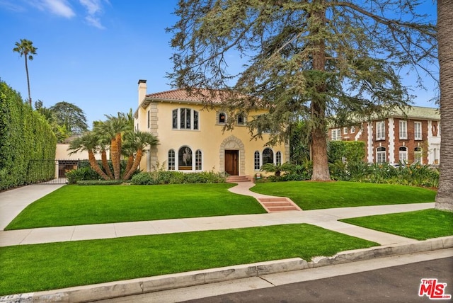 mediterranean / spanish house with a front yard