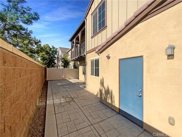 view of side of property featuring a patio area