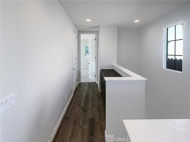 corridor featuring dark hardwood / wood-style floors