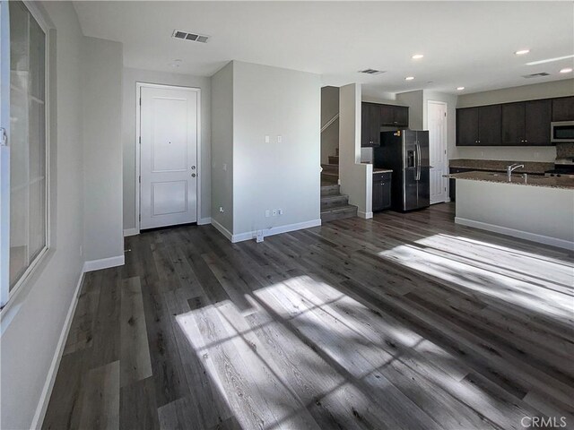 unfurnished living room featuring dark hardwood / wood-style flooring