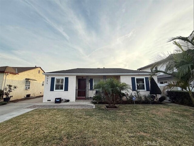 ranch-style home with covered porch and a front yard