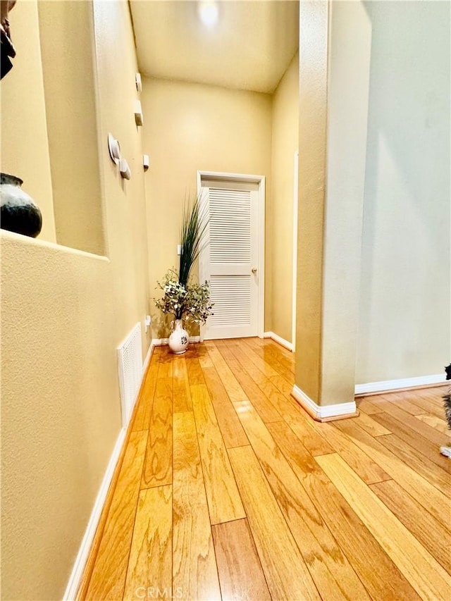 hallway with hardwood / wood-style floors