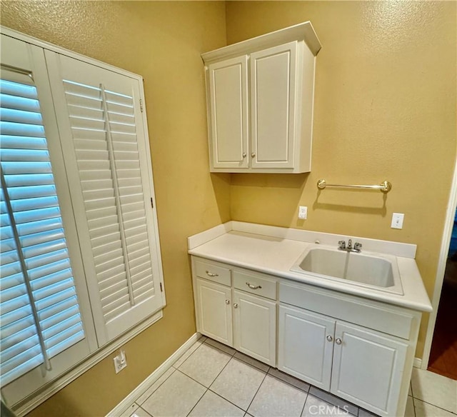 washroom with sink and light tile patterned floors