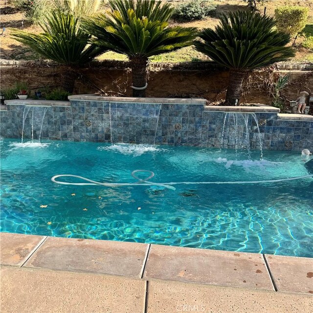 view of swimming pool featuring pool water feature