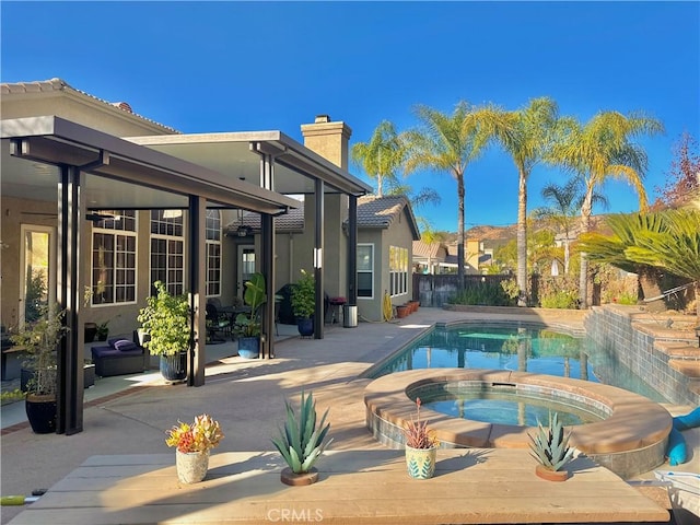 view of swimming pool with an in ground hot tub and a patio area