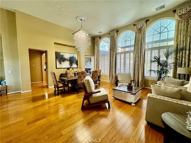 interior space with a chandelier, light hardwood / wood-style floors, and a wealth of natural light