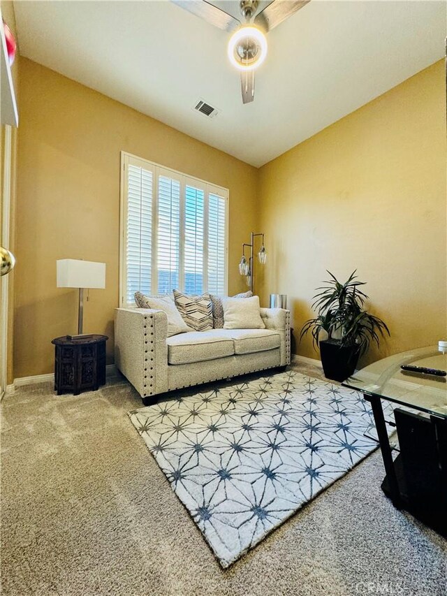 living room featuring ceiling fan and carpet flooring