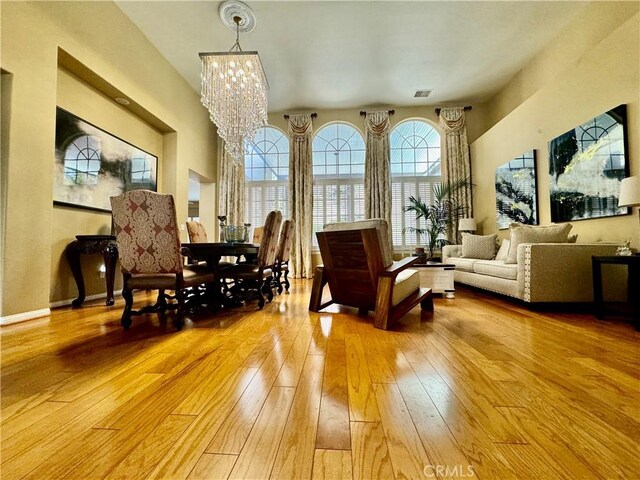 sitting room with an inviting chandelier and light hardwood / wood-style flooring