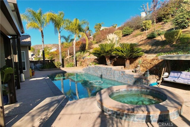 view of swimming pool featuring an in ground hot tub and a mountain view