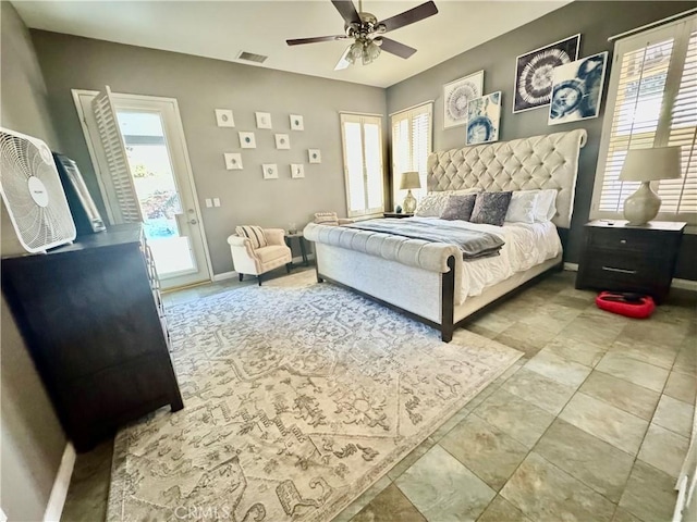 bedroom with multiple windows, access to exterior, and ceiling fan