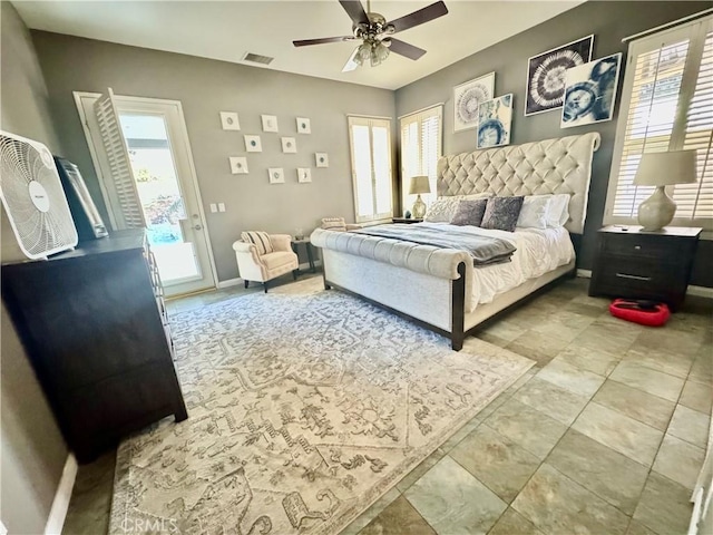 bedroom with multiple windows, access to exterior, and ceiling fan