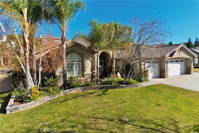 mediterranean / spanish-style home featuring a front lawn and a garage