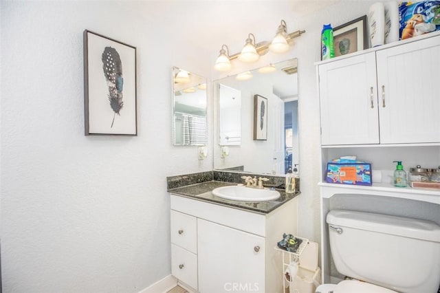 bathroom with toilet and vanity