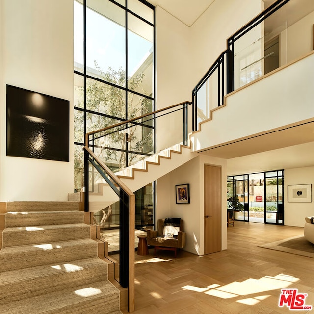 staircase featuring a towering ceiling