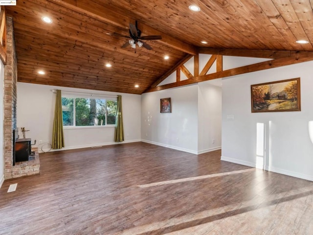 unfurnished living room featuring wooden ceiling, a wood stove, dark hardwood / wood-style floors, and vaulted ceiling with beams