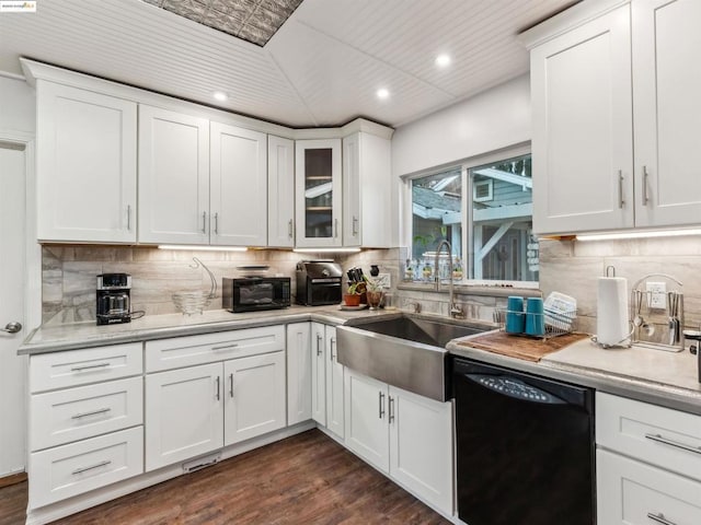 kitchen with dark wood-type flooring, white cabinetry, black dishwasher, sink, and backsplash