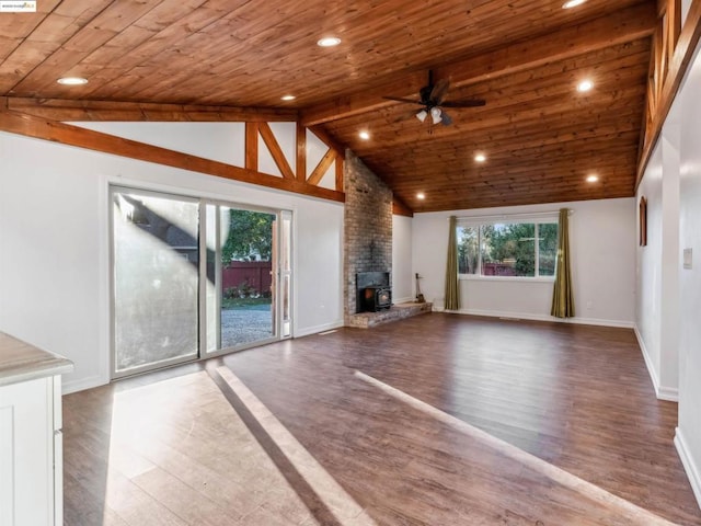 unfurnished living room with ceiling fan, hardwood / wood-style floors, beam ceiling, high vaulted ceiling, and wooden ceiling