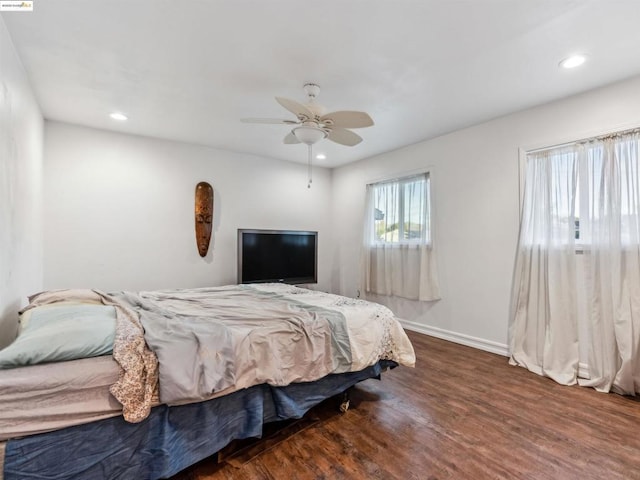 bedroom with ceiling fan and dark wood-type flooring