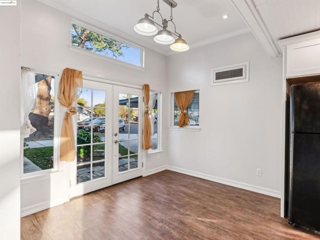 entryway featuring hardwood / wood-style flooring, ornamental molding, and french doors