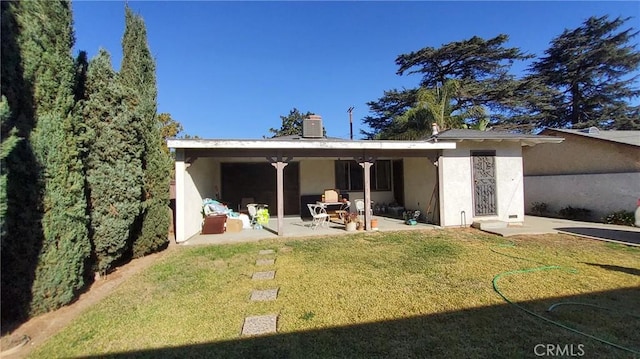 rear view of house with central AC unit, a patio area, and a lawn