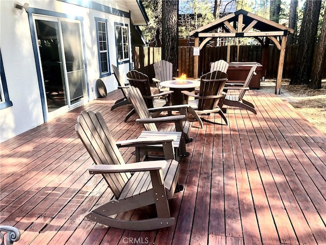 deck with a gazebo and a hot tub