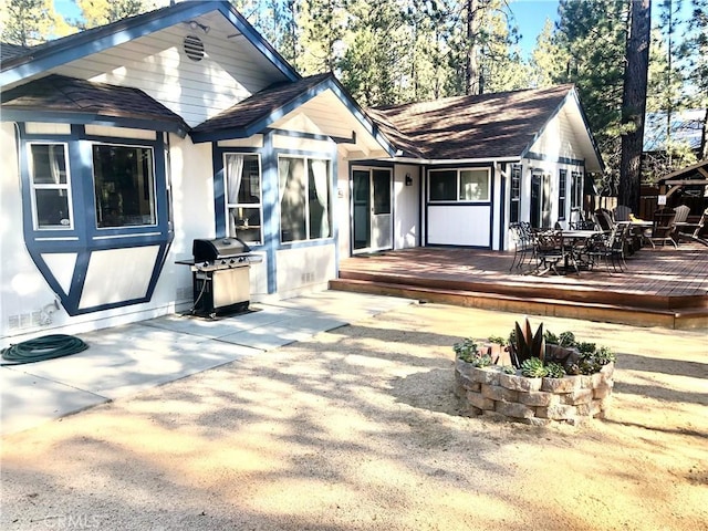 back of house featuring a wooden deck