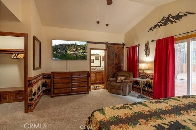 bedroom with light carpet, a closet, vaulted ceiling, and ensuite bathroom