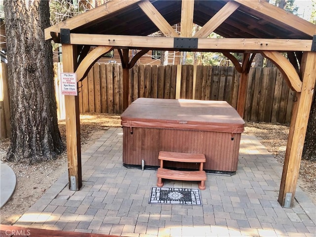 view of patio / terrace featuring a gazebo and a hot tub