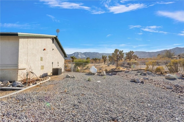 exterior space featuring central AC and a mountain view