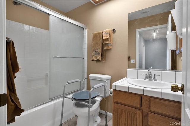 full bathroom featuring toilet, bath / shower combo with glass door, tile patterned floors, and vanity