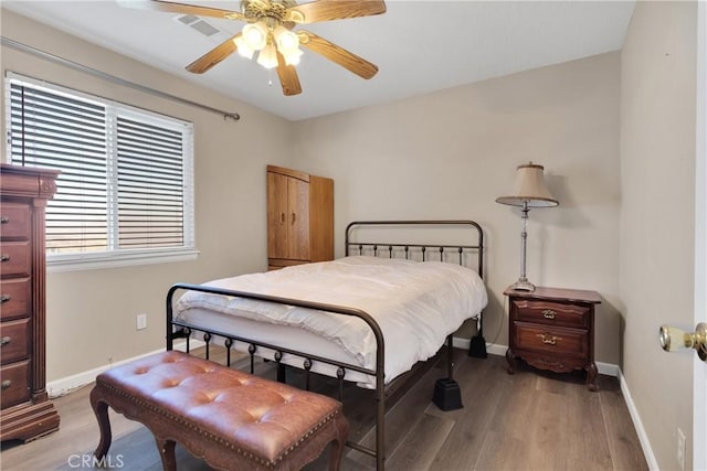 bedroom with ceiling fan and wood-type flooring