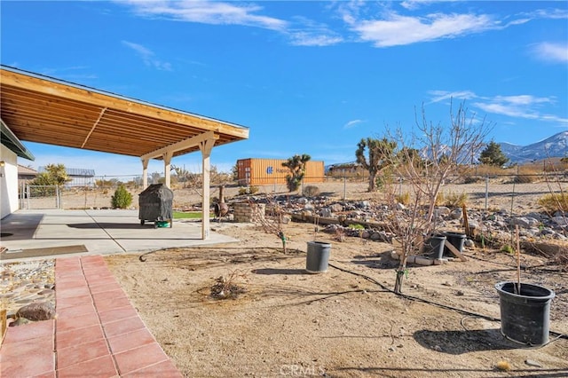 view of yard with a mountain view and a patio