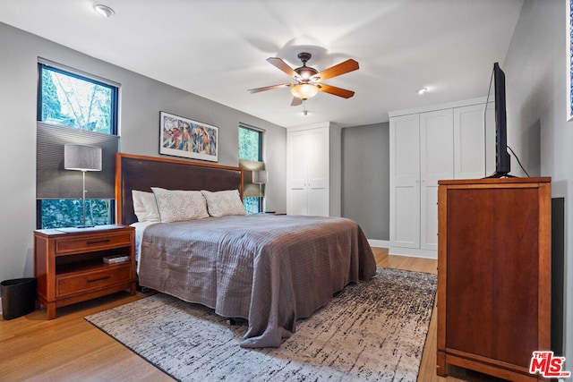 bedroom with ceiling fan and light hardwood / wood-style flooring