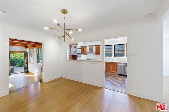 interior space featuring light wood-type flooring, a chandelier, and crown molding