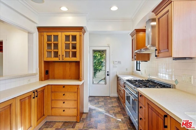 kitchen featuring double oven range, backsplash, crown molding, and wall chimney exhaust hood