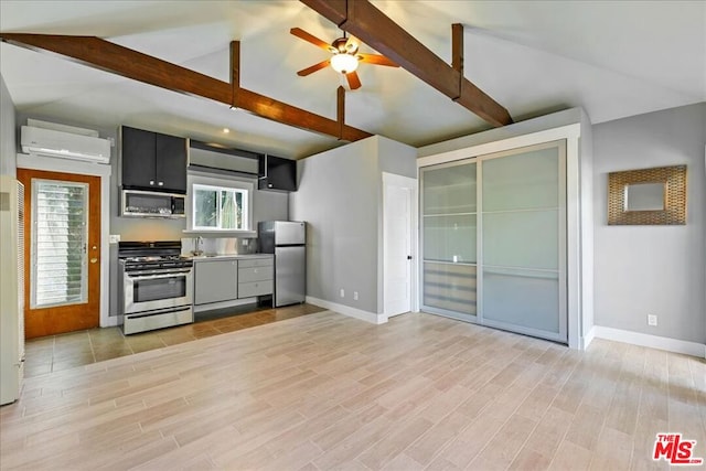 kitchen featuring stainless steel appliances, vaulted ceiling with beams, light hardwood / wood-style floors, ceiling fan, and a wall mounted air conditioner