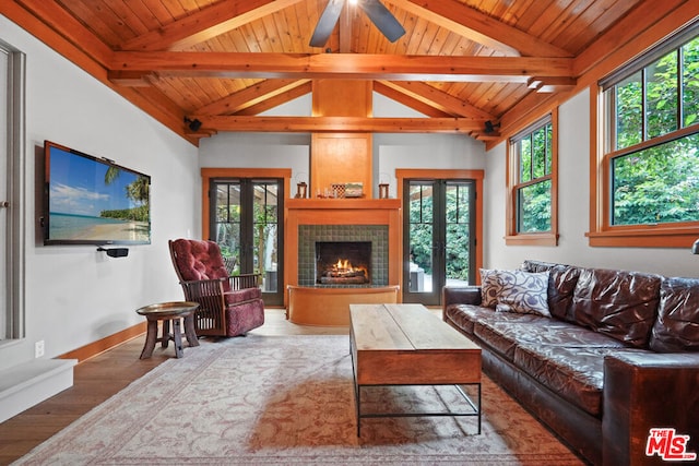 living room with french doors, a wealth of natural light, and wood-type flooring