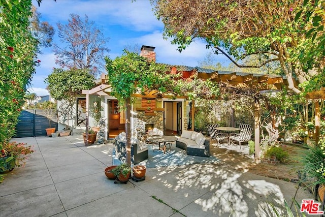 view of patio / terrace with an outdoor living space with a fireplace