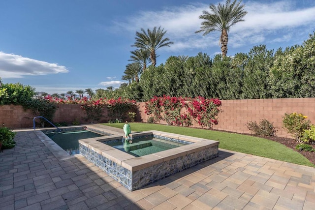 view of swimming pool with an in ground hot tub