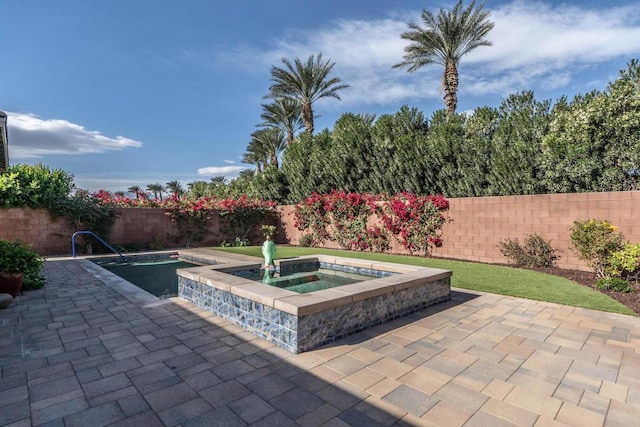 view of patio / terrace with a swimming pool with hot tub