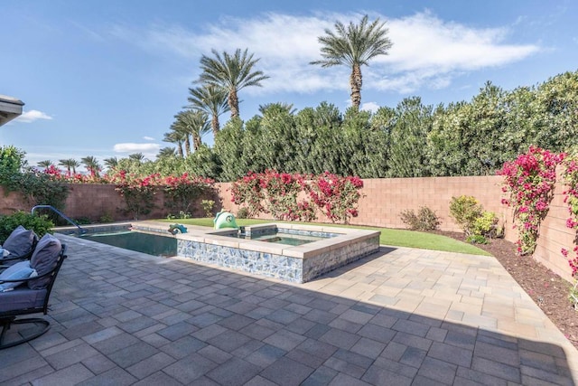 view of pool featuring an in ground hot tub and a patio