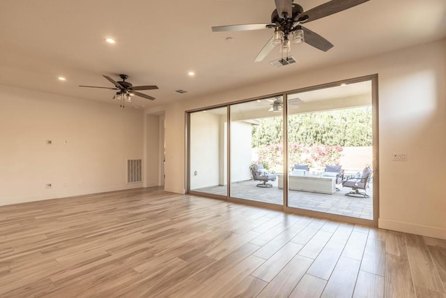 unfurnished room with ceiling fan and light hardwood / wood-style flooring