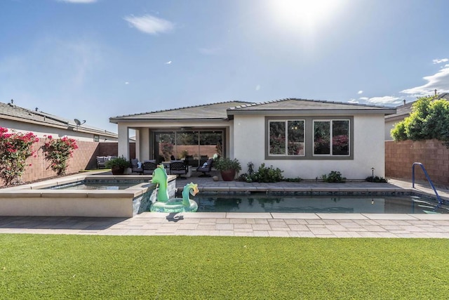 back of house with a lawn, a swimming pool with hot tub, outdoor lounge area, and a patio