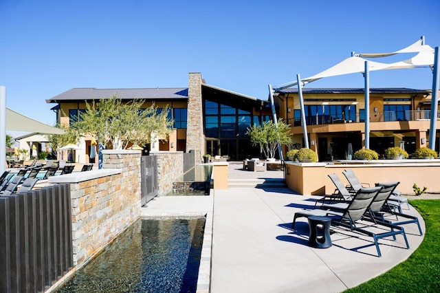 view of property's community featuring a patio area