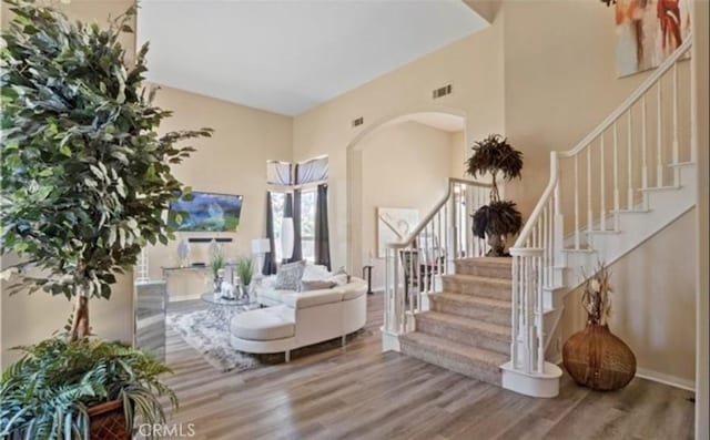 interior space featuring hardwood / wood-style flooring and a high ceiling