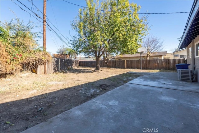 view of yard featuring central AC unit and a patio area